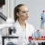 female-researcher-laboratory-with-test-tubes-safety-glasses-male-colleague